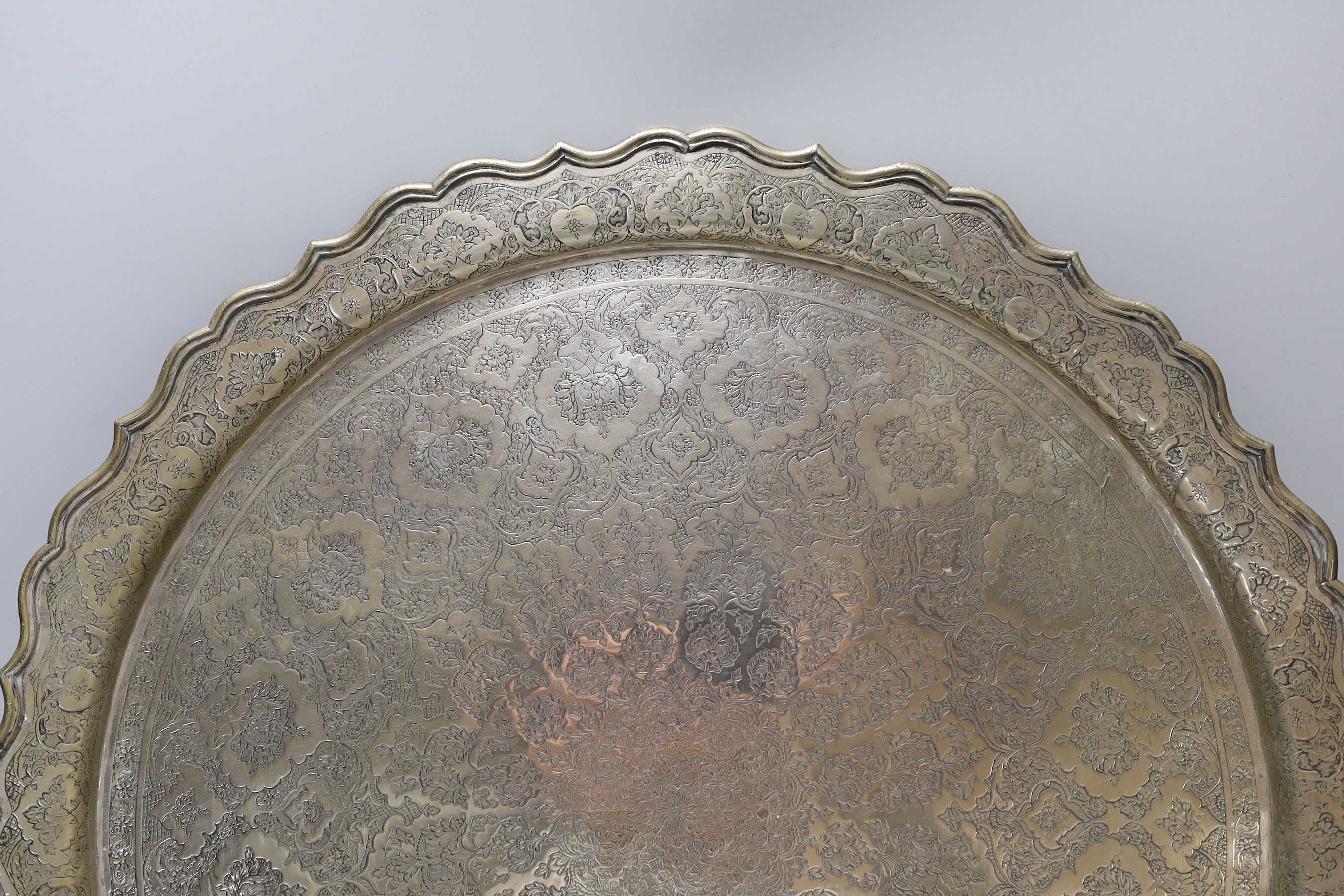 A Persian engraved white metal tray, 43.7cm, 49oz.